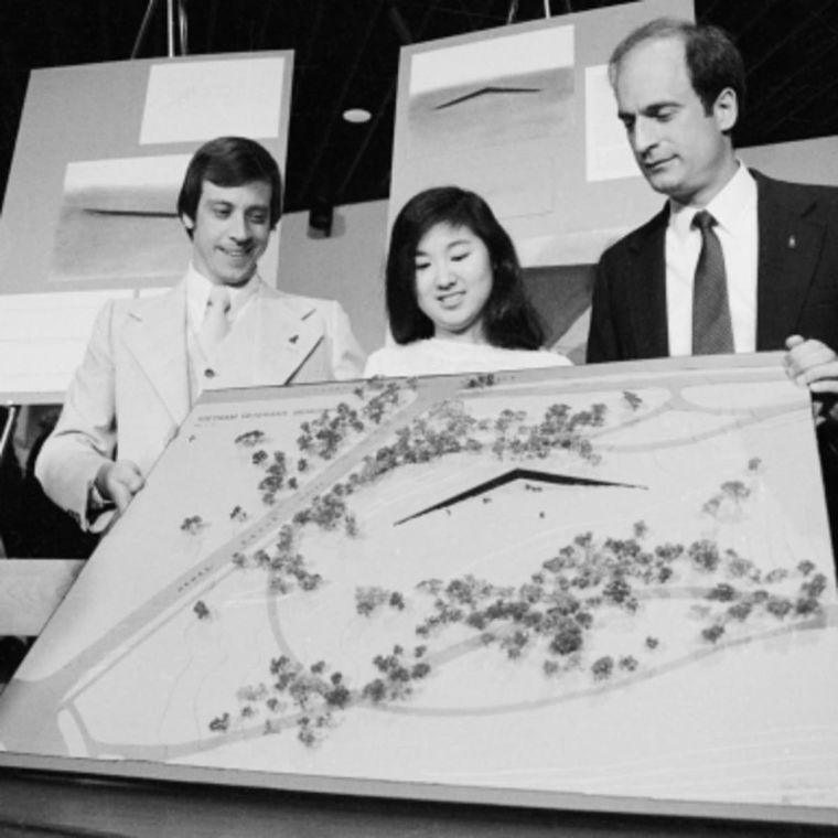 Jan C. Scruggs (L), President of the Vietnam Veteran’s Memorial Fund, and Project Director Bob Doubek (R) display the final design for memorial, designed by Yale architecture student Maya Ying Lin.

(Credit: Bettmann/Getty Images)
